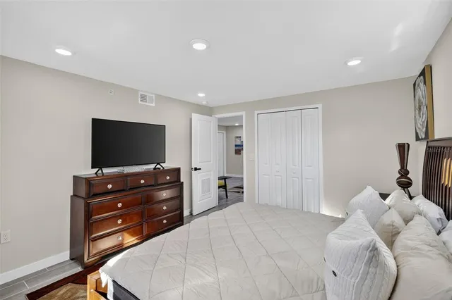 a bedroom with a bed and a flat screen tv