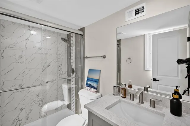 a bathroom with a sink toilet and shower