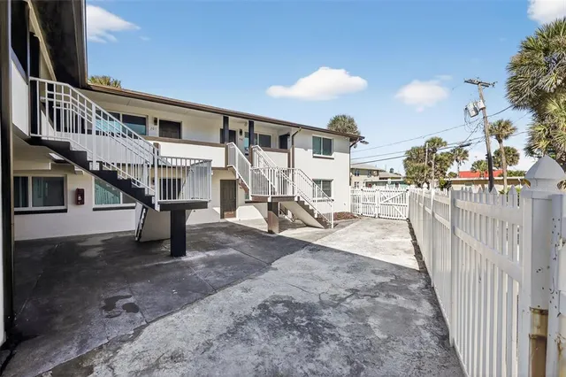 a view of a house with a wooden deck
