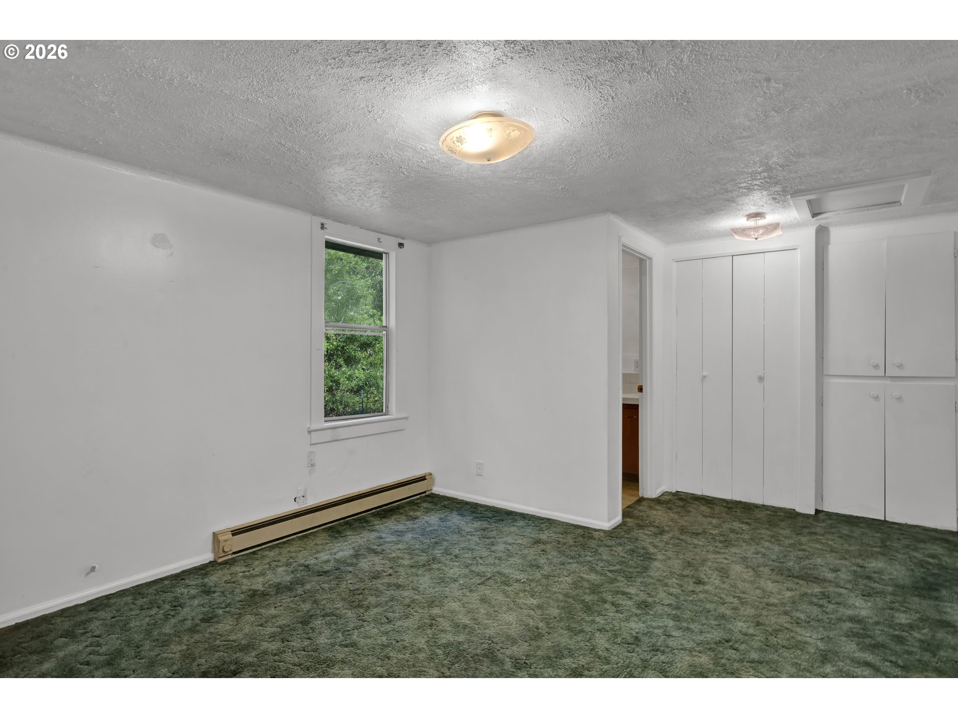 777 Rhododendron Drive Florence, OR 97439 - Photo 15 of 41 a view of an empty room with window and hardwood floor