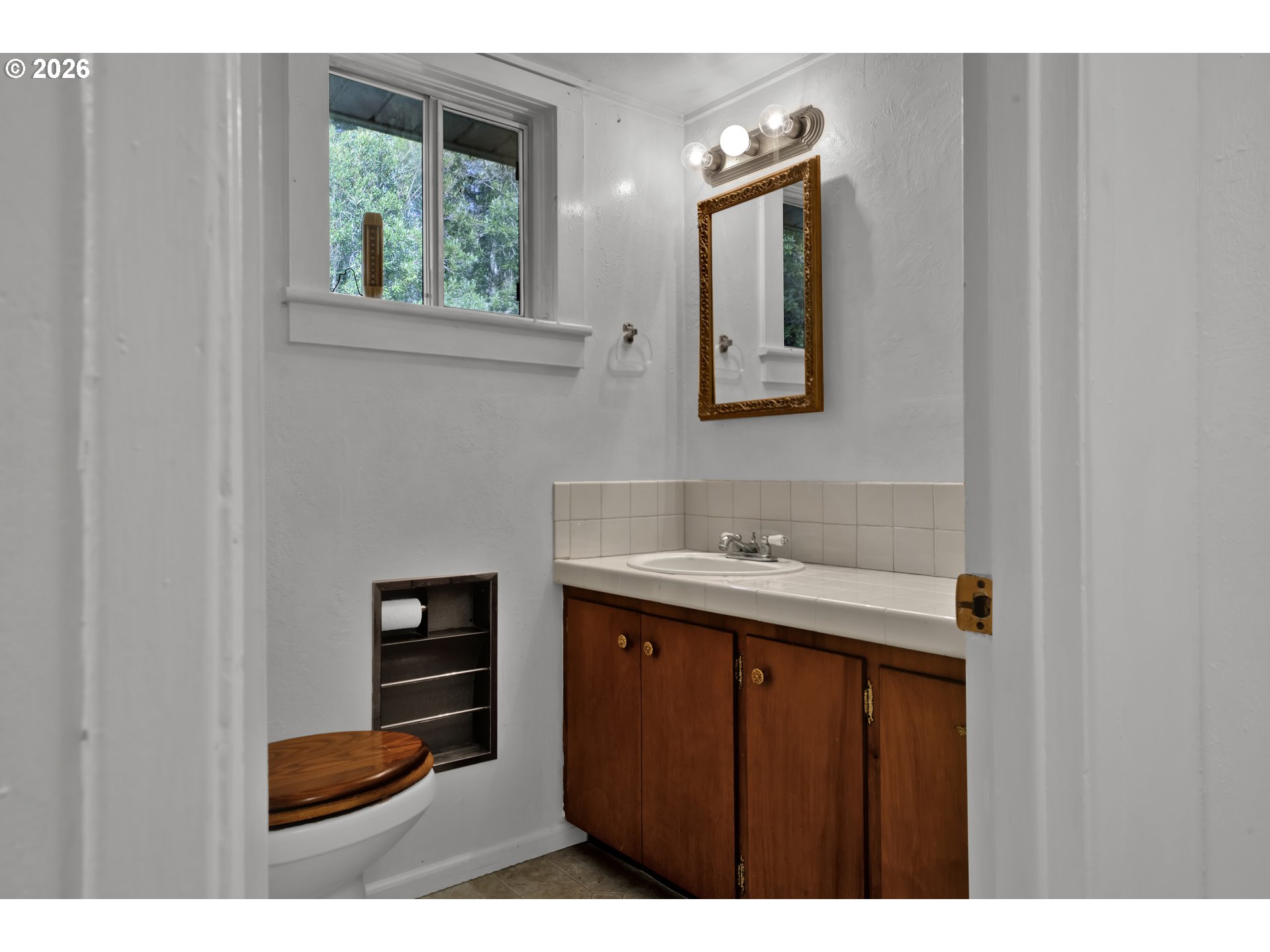 777 Rhododendron Drive Florence, OR 97439 - Photo 17 of 41 a bathroom with a sink and a mirror