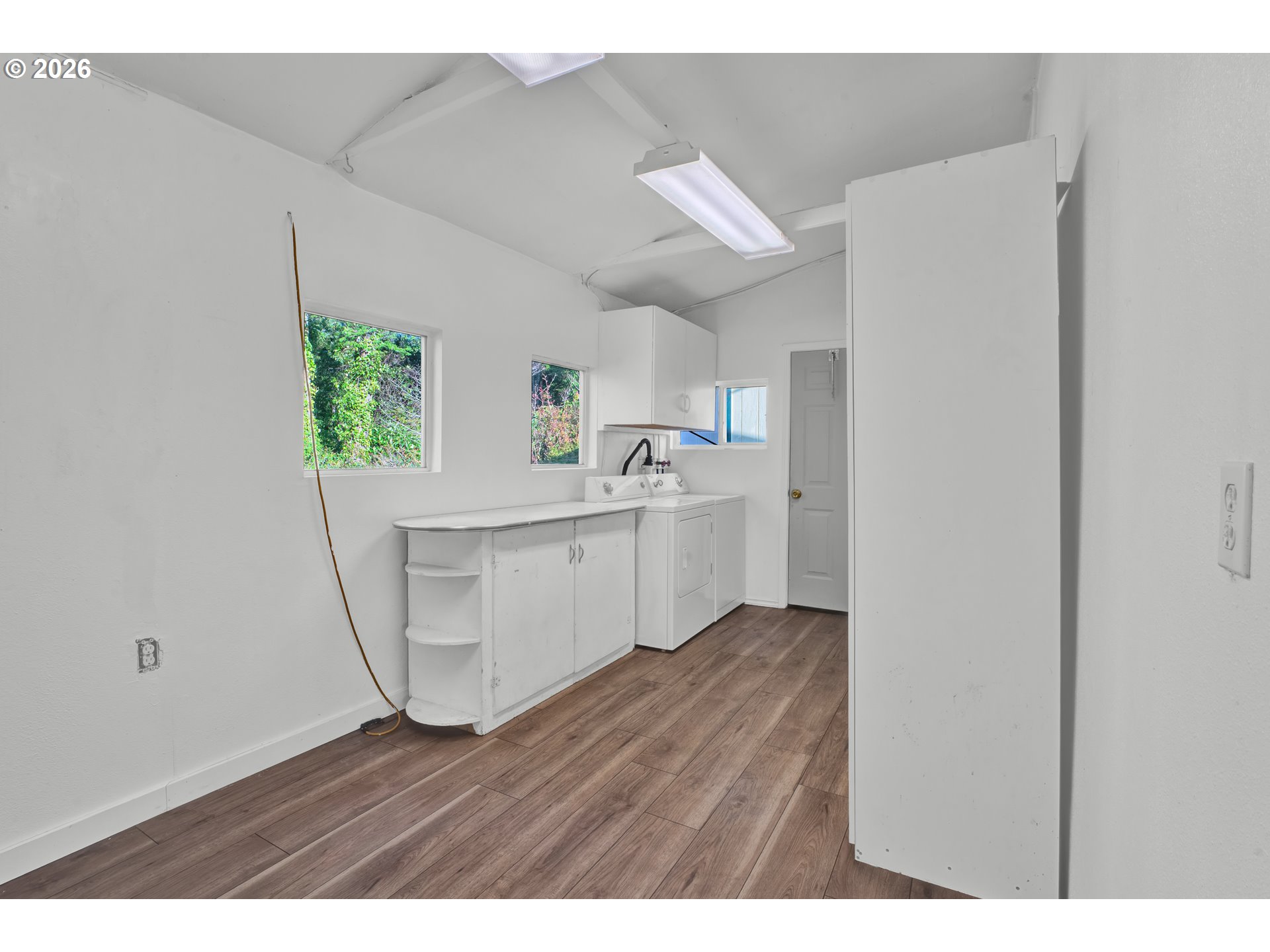 777 Rhododendron Drive Florence, OR 97439 - Photo 22 of 41 a view of a kitchen with wooden floor and electronic appliances