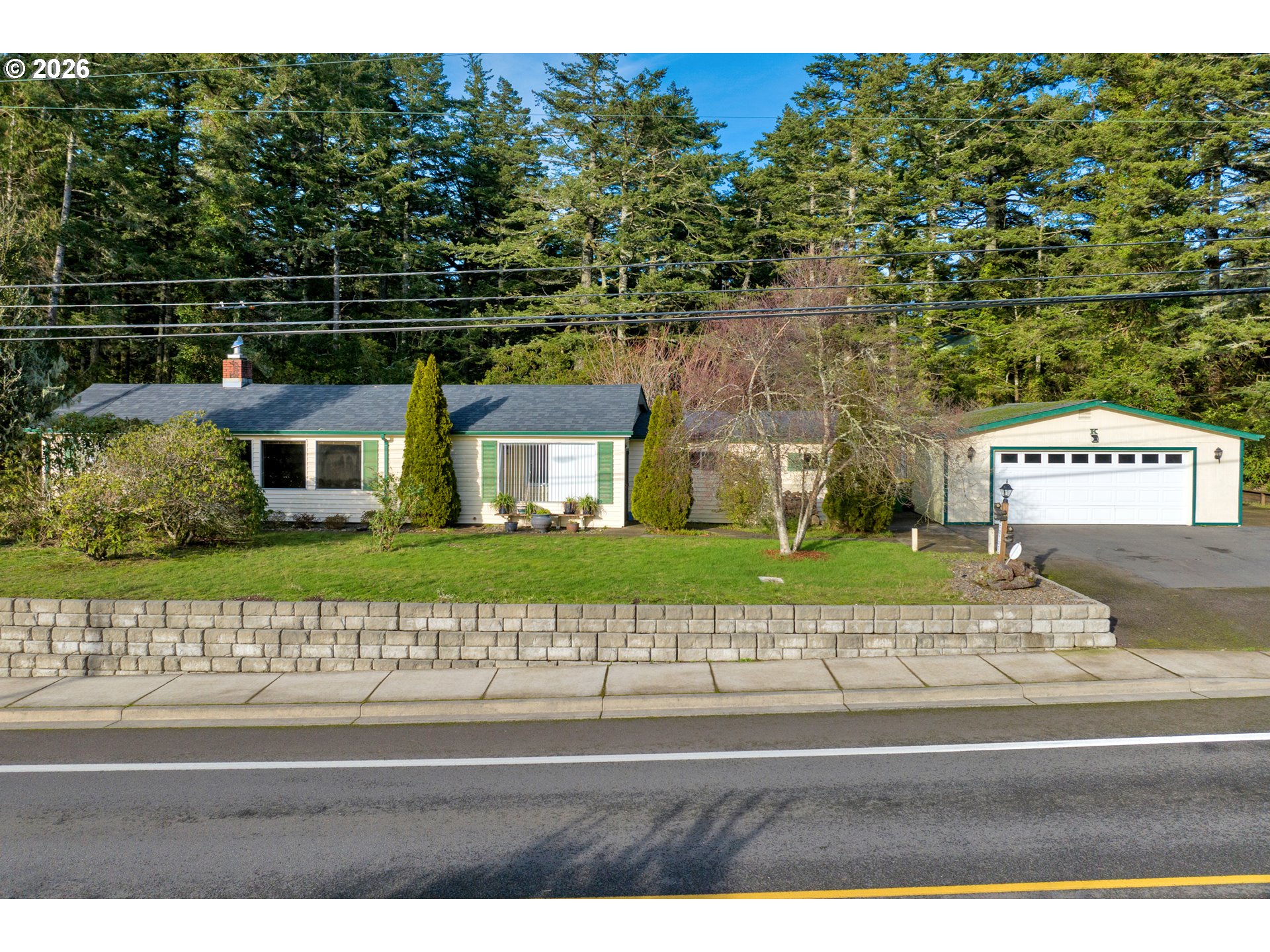 777 Rhododendron Drive Florence, OR 97439 - Photo 29 of 41 a front view of a house with a garden