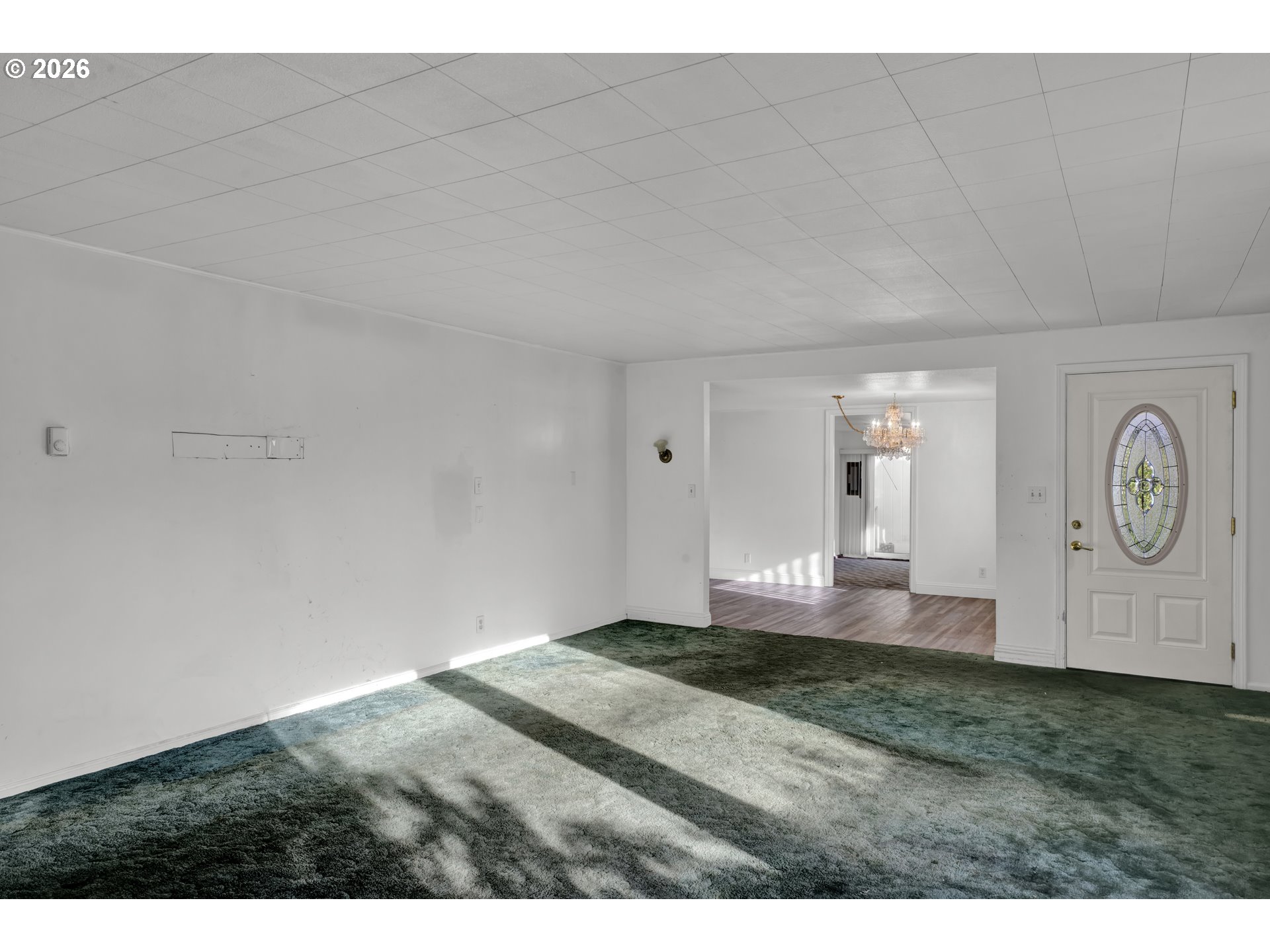 777 Rhododendron Drive Florence, OR 97439 - Photo 7 of 41 a bedroom with a bed and a chandelier