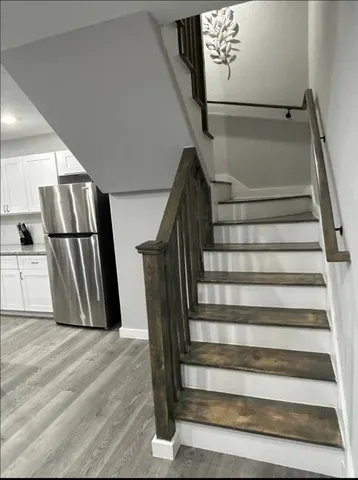 a view of staircase with white walls and stairs