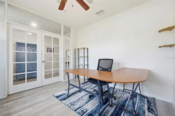 a dining room with furniture fireplace and wooden floor