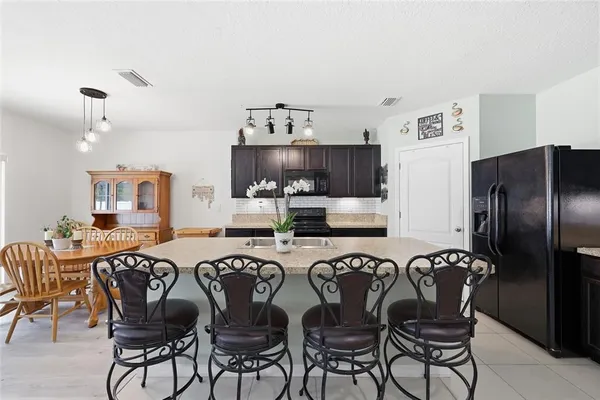 a living room with furniture a ceiling fan and a window