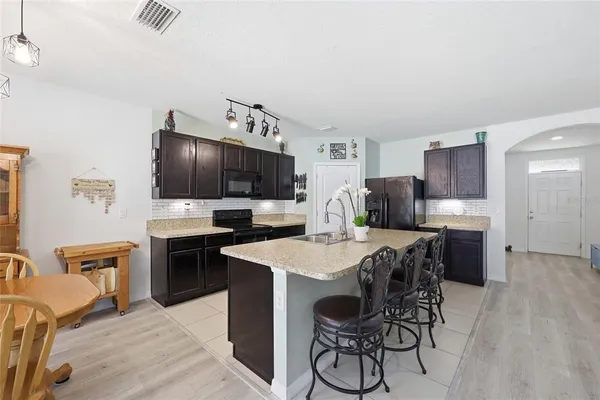 a living room with furniture a flat screen tv and a window