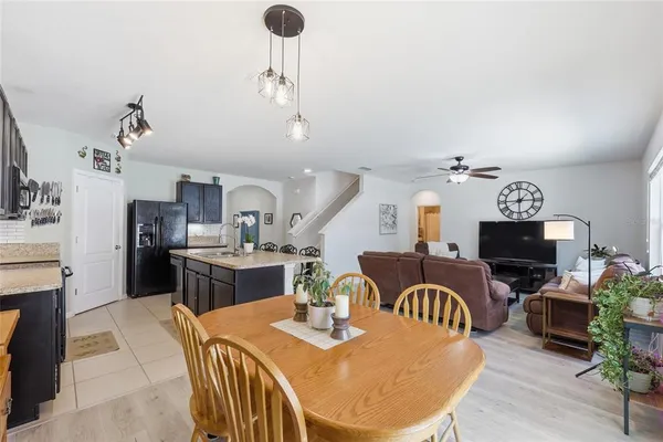 a spacious bedroom with a bed and a chandelier