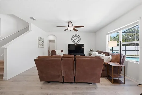a spacious bedroom with a bed and a flat screen television