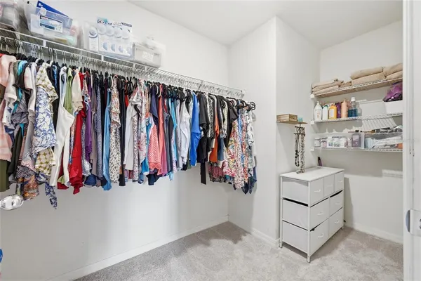 a bathroom with a granite countertop sink a mirror and shower