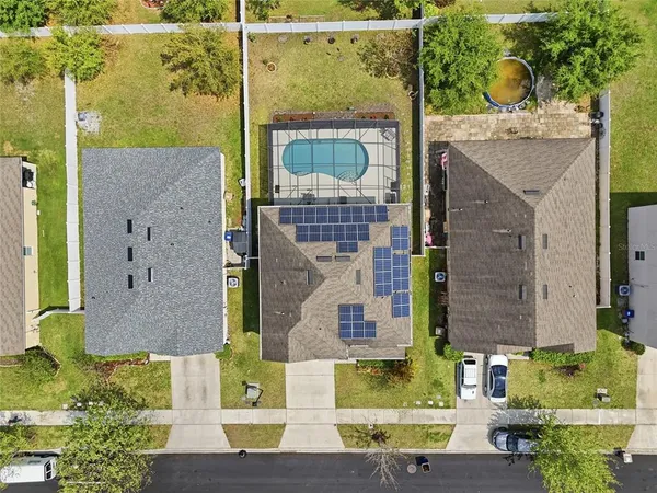 aerial view of a house with a street