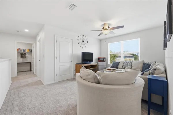 a view of a swimming pool with a table and chairs under an umbrella