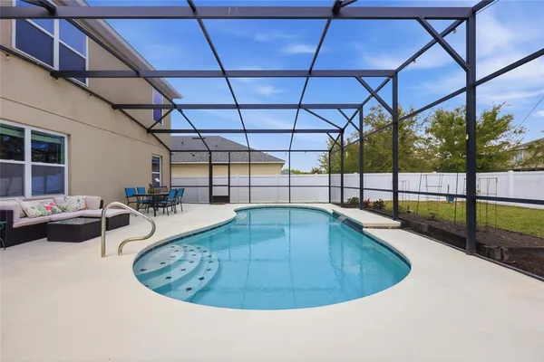 an aerial view of a house with a yard and green space