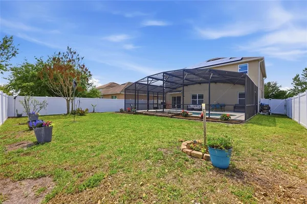 an aerial view of residential houses with outdoor space and swimming pool