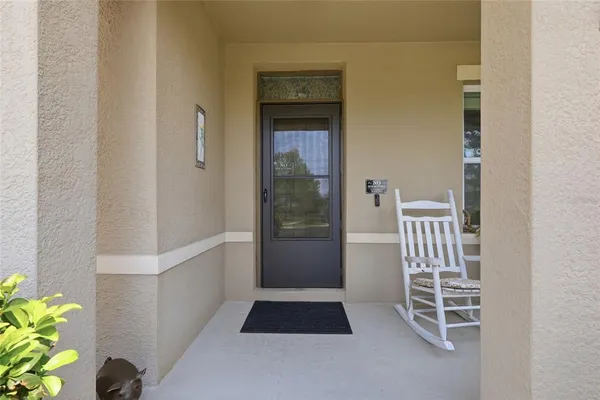 a hallway with wooden floor chandelier