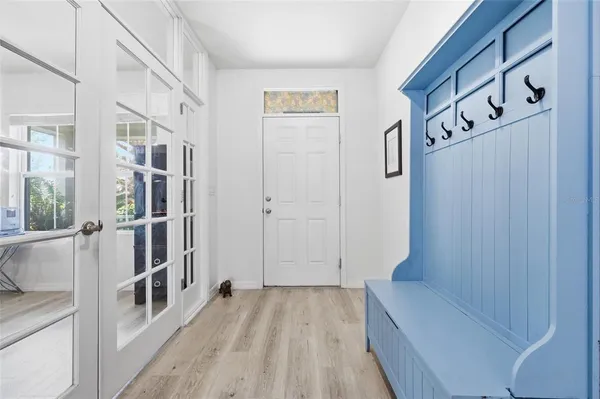 a kitchen with stainless steel appliances granite countertop a table chairs stove and refrigerator