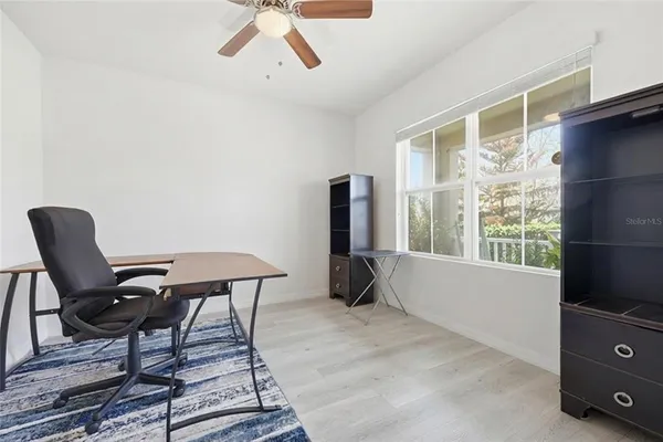 a kitchen with stainless steel appliances a microwave sink stove refrigerator dining table and chairs