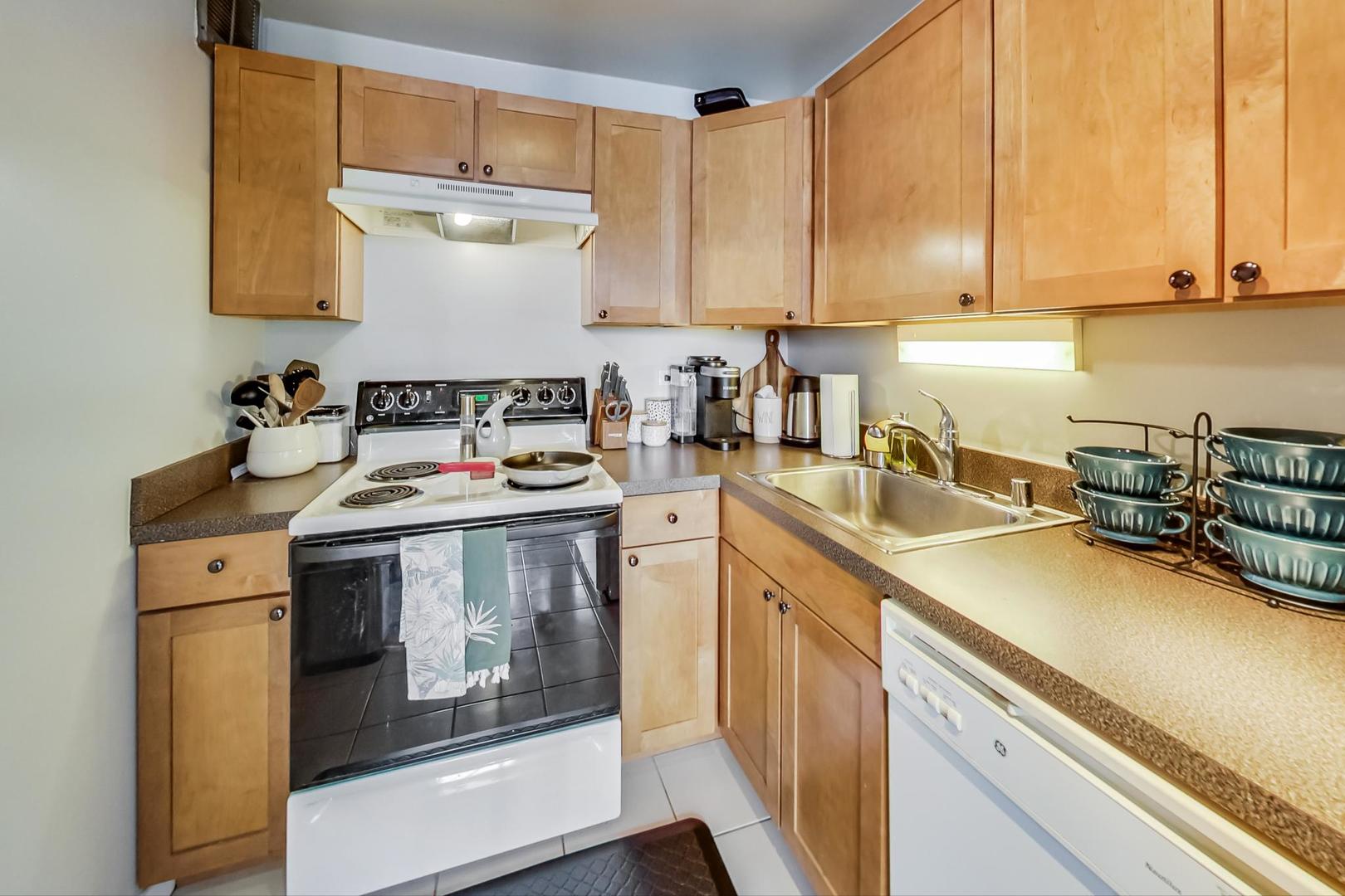 655 West Irving Park Road, Unit 1908 Chicago, IL 60613 - Photo 13 of 29 a kitchen with a sink stove and cabinets