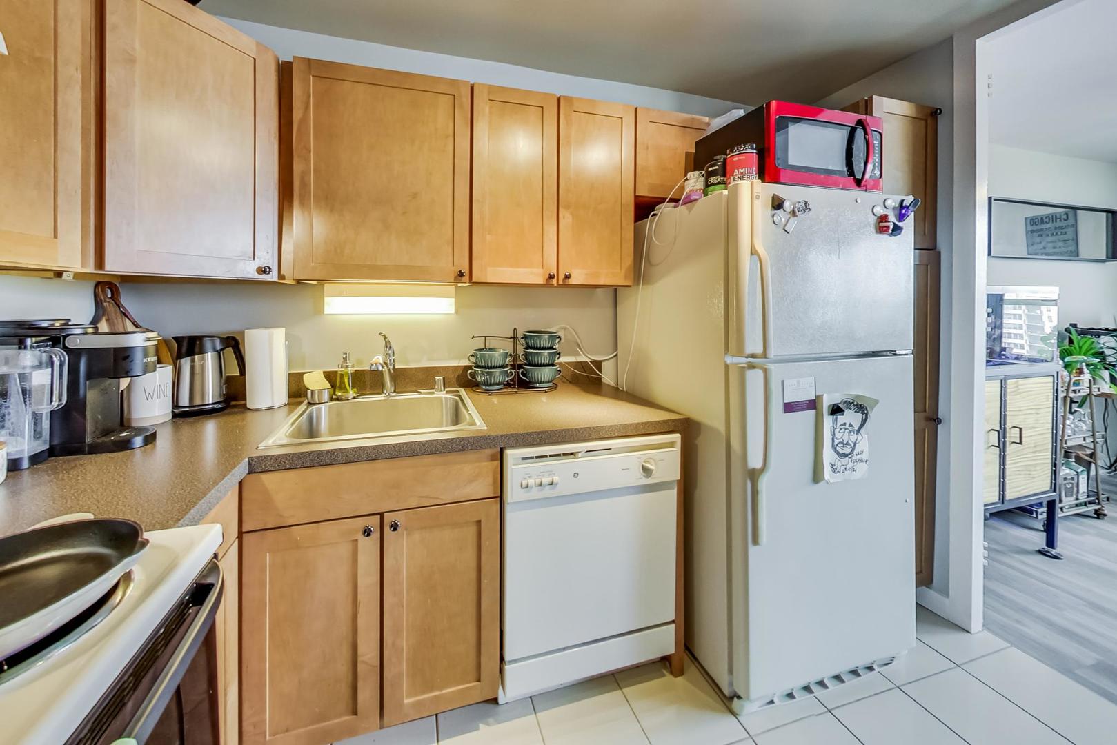 655 West Irving Park Road, Unit 1908 Chicago, IL 60613 - Photo 14 of 29 a white refrigerator freezer sitting in a kitchen