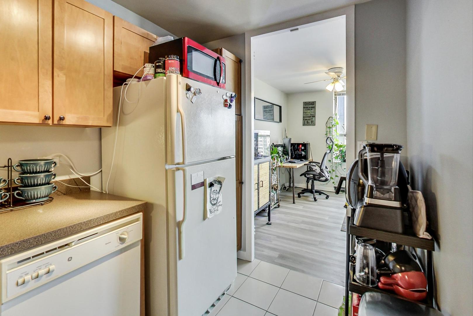 655 West Irving Park Road, Unit 1908 Chicago, IL 60613 - Photo 15 of 29 a open kitchen with stainless steel appliances granite countertop a refrigerator and a stove top oven