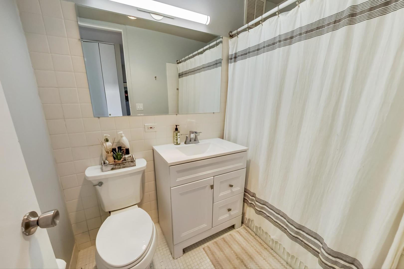 655 West Irving Park Road, Unit 1908 Chicago, IL 60613 - Photo 16 of 29 a bathroom with a sink a toilet and shower