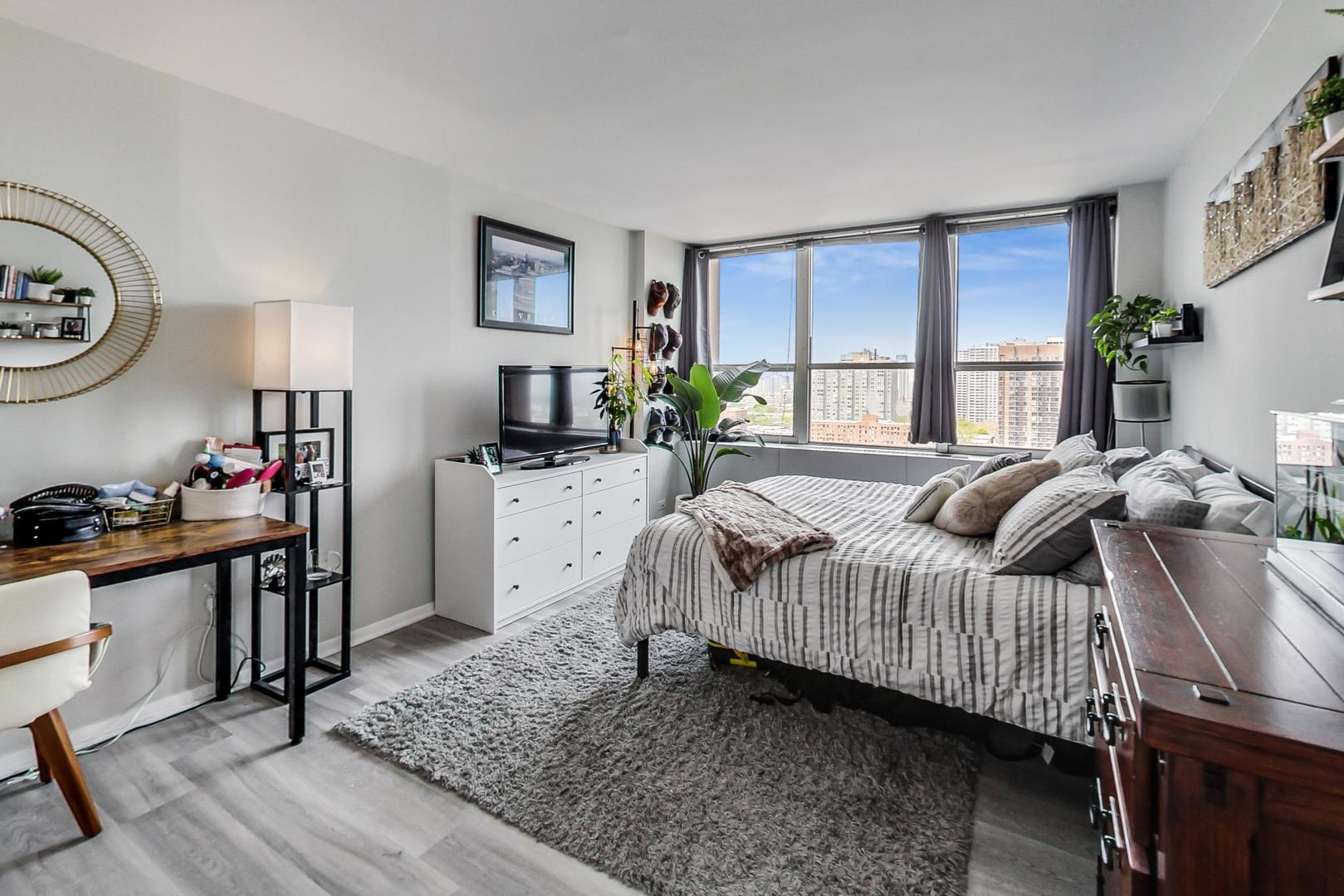 655 West Irving Park Road, Unit 1908 Chicago, IL 60613 - Photo 18 of 29 a bedroom with a bed next to a window with the outer view
