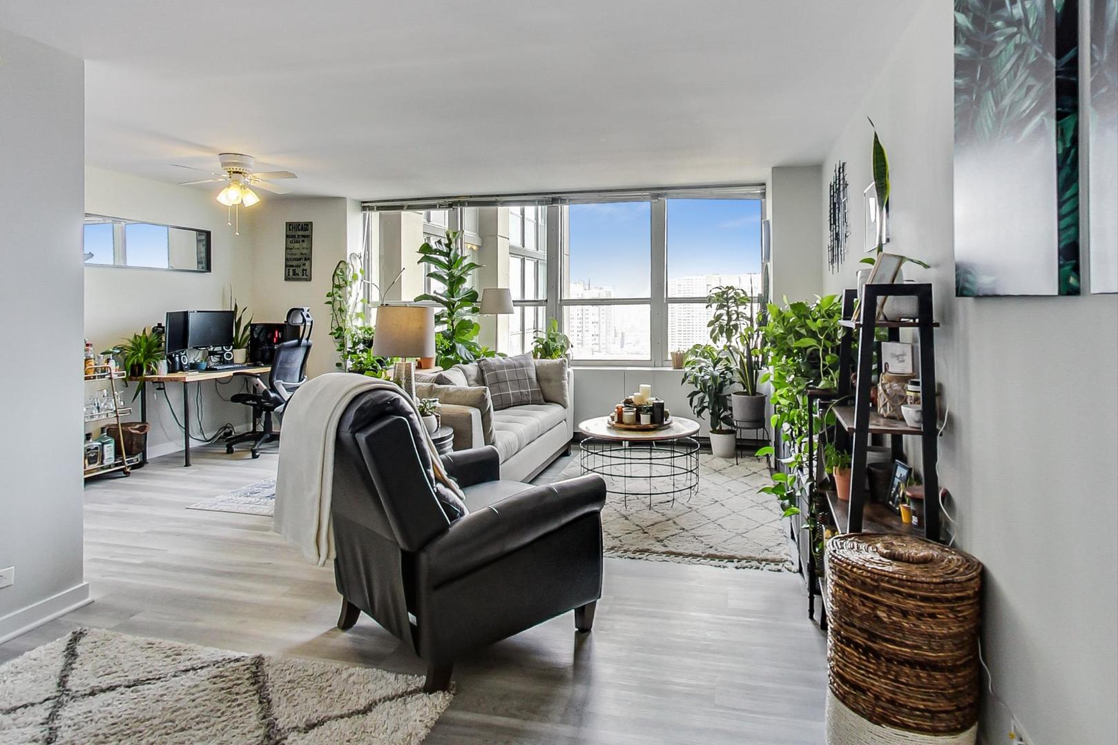 655 West Irving Park Road, Unit 1908 Chicago, IL 60613 - Photo 6 of 29 a living room with furniture a potted plant and a large window