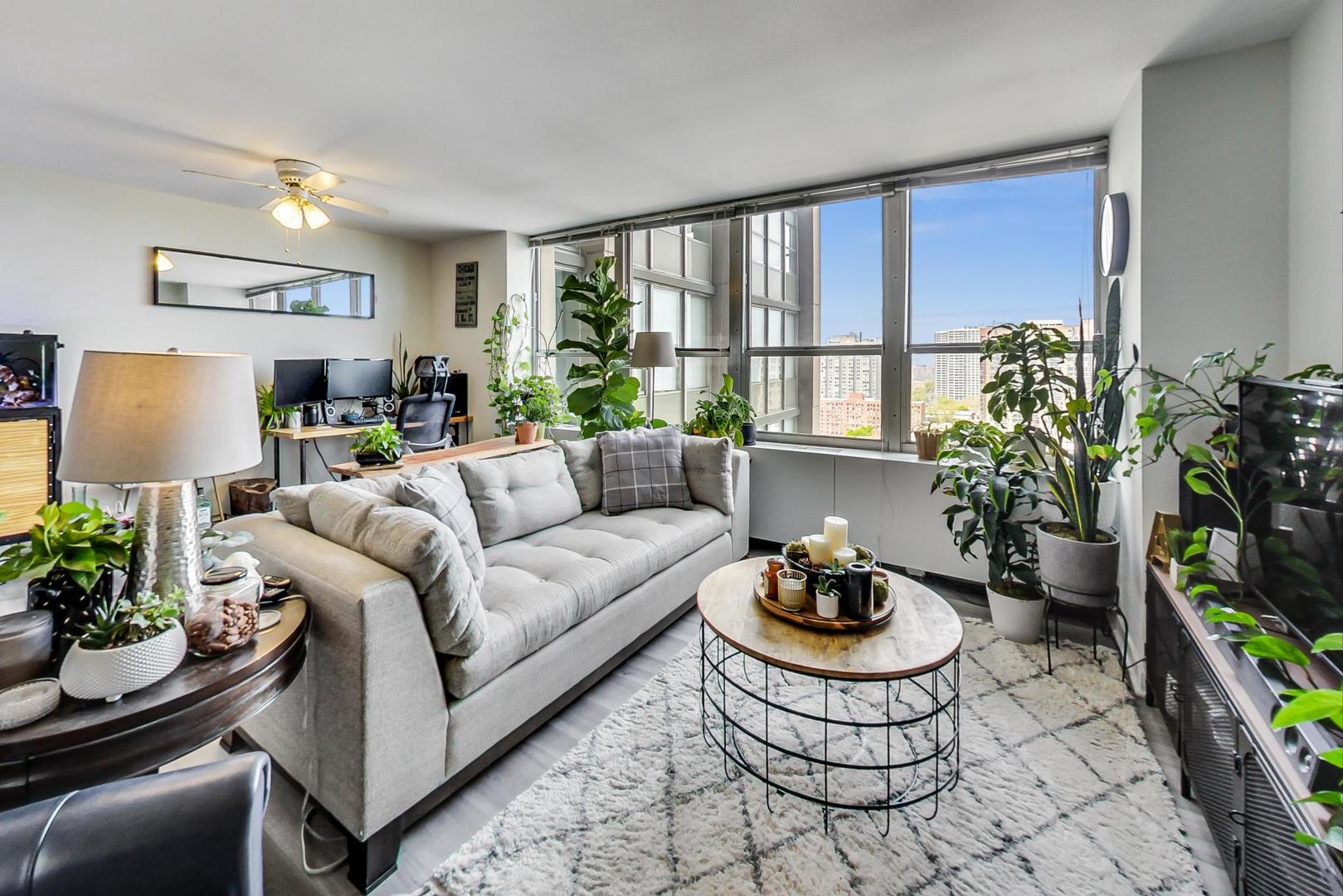 655 West Irving Park Road, Unit 1908 Chicago, IL 60613 - Photo 7 of 29 a living room with furniture and a potted plant