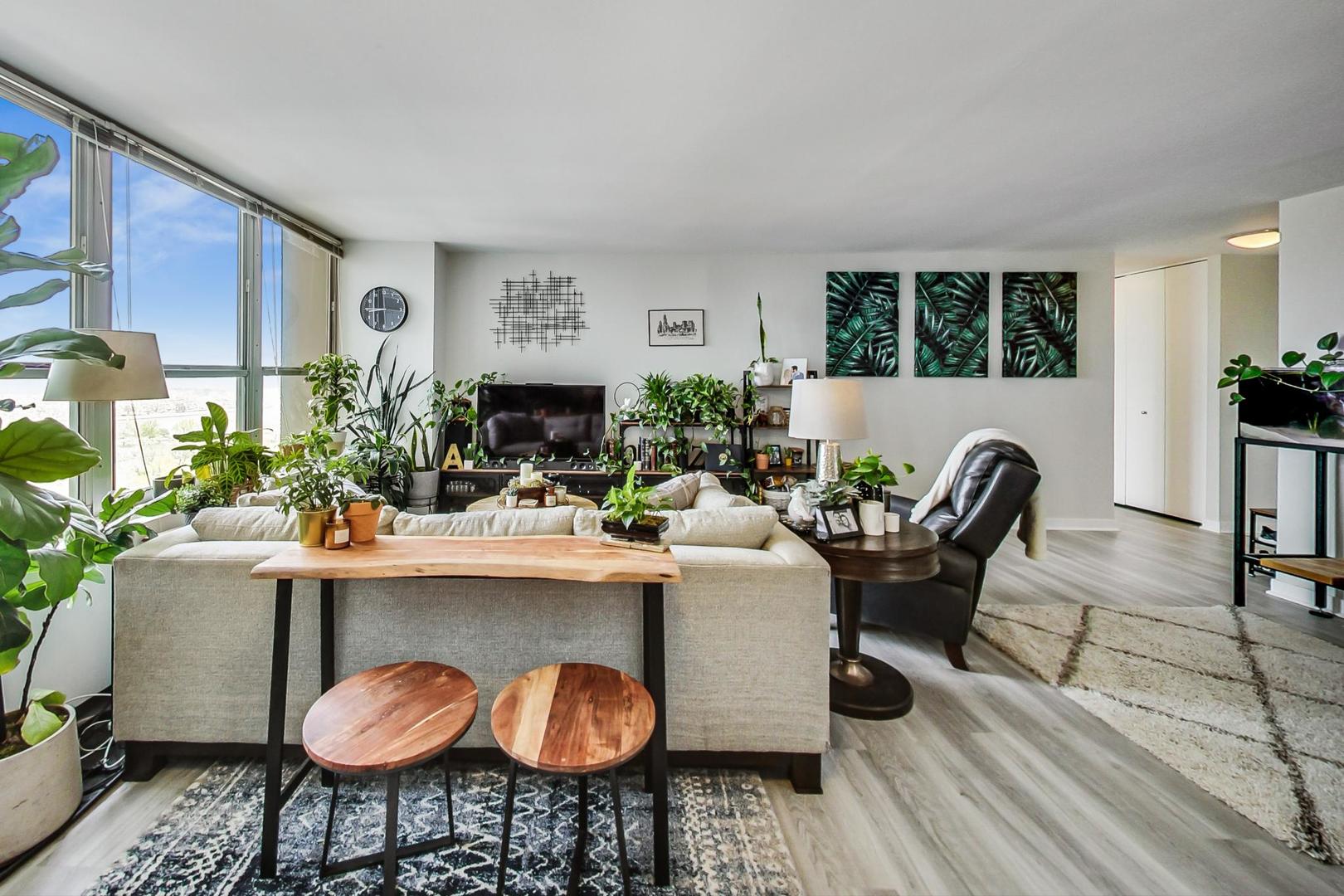 655 West Irving Park Road, Unit 1908 Chicago, IL 60613 - Photo 8 of 29 a dining room with furniture and wooden floor