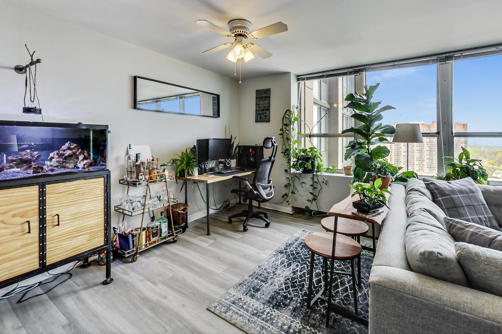 655 West Irving Park Road, Unit 1908 Chicago, IL 60613 - Photo 10 of 29 a living room with furniture gym equipment and a large window