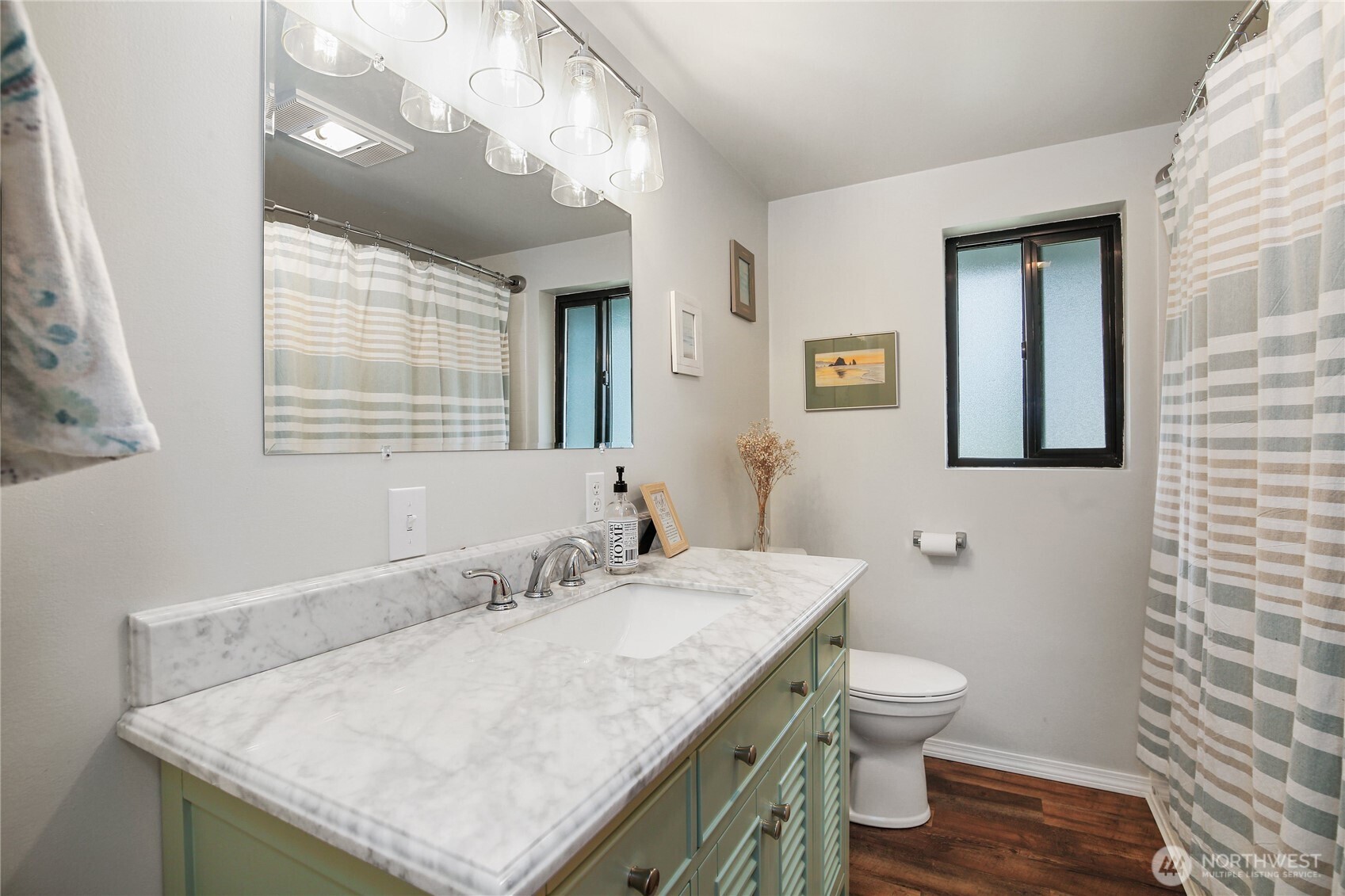 1968 State Route 105 Aberdeen, WA 98520 - Photo 18 of 39 a bathroom with a granite countertop sink a toilet and a mirror