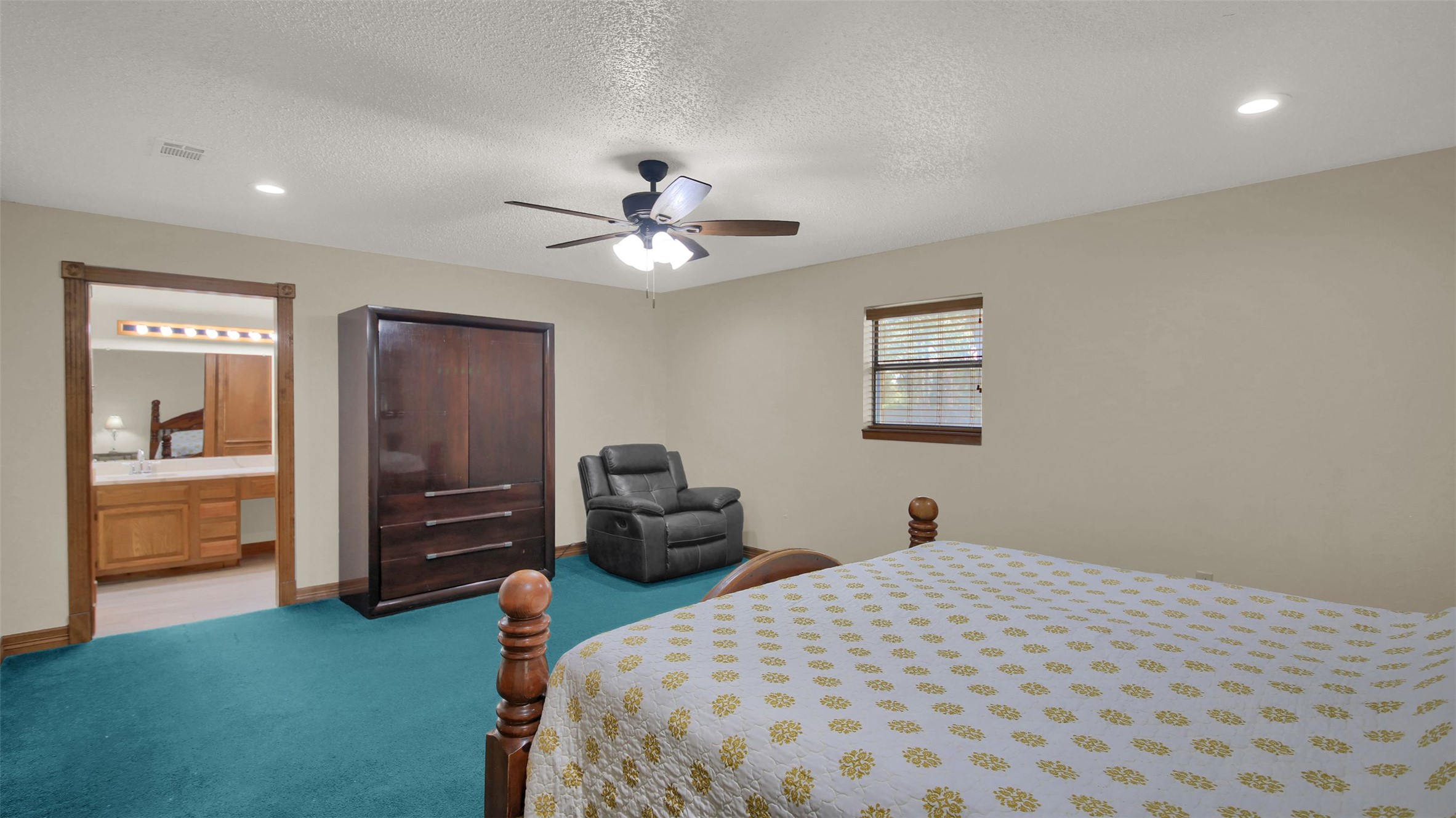 191 Jordan Lane Elgin, TX 78621 - Photo 16 of 29 Recessed lighting and a classic wood-trimmed window frame this comfortable, carpeted private retreat.
