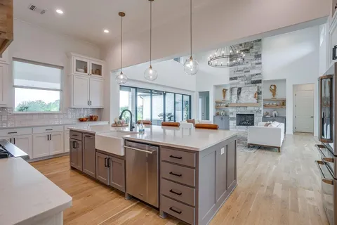 a kitchen with cabinets and wooden floor