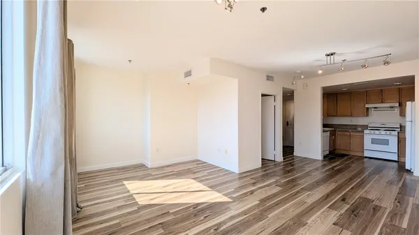 a view of a kitchen with a sink and a refrigerator