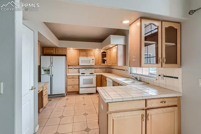 a kitchen with a sink cabinets and window