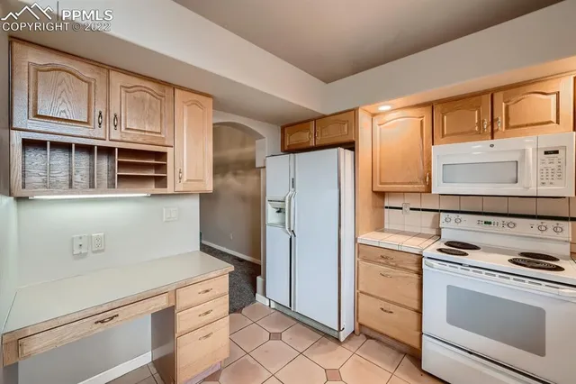 a kitchen with stainless steel appliances a refrigerator stove and cabinets
