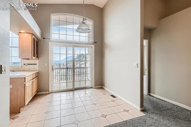 a view of an empty room with a kitchen