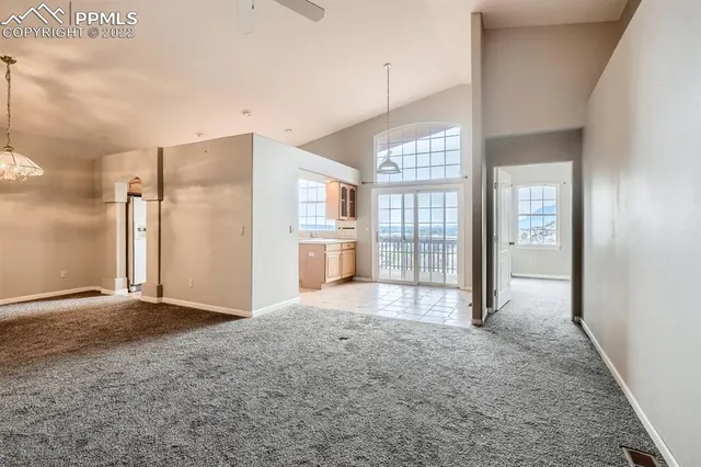a view of livingroom with an empty space and windows