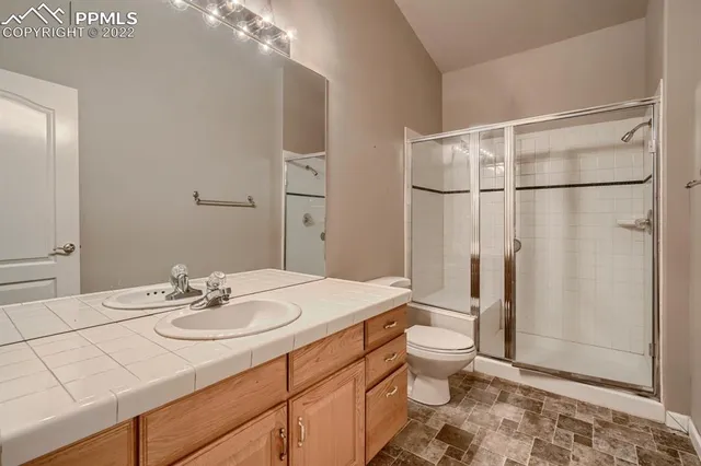 a bathroom with a sink toilet and shower