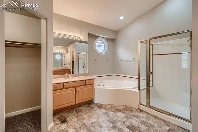 a bathroom with a tub sink and a mirror