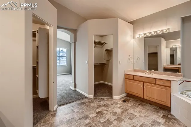 a spacious bathroom with a shower sink and mirror