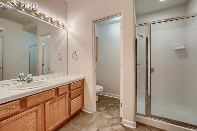 a spacious bathroom with a double vanity sink toilet and shower