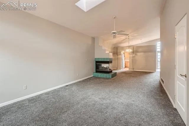 a view of a big room with chandelier and windows