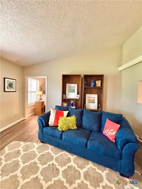 503 16th Street Port O'Connor, TX 77982 - Photo 12 of 48 a living room with a couch and dresser with wooden floor