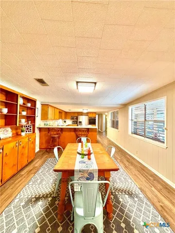 a view of a room with wooden floor and windows