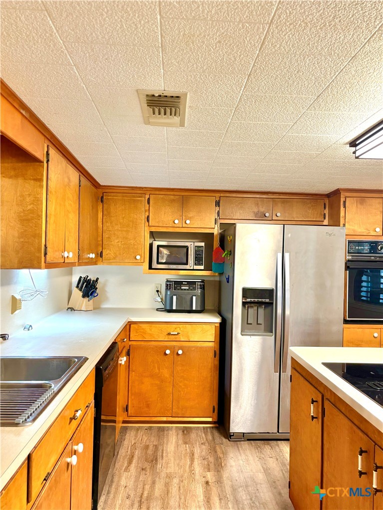 503 16th Street Port O'Connor, TX 77982 - Photo 20 of 48 a kitchen with stainless steel appliances a sink and a refrigerator