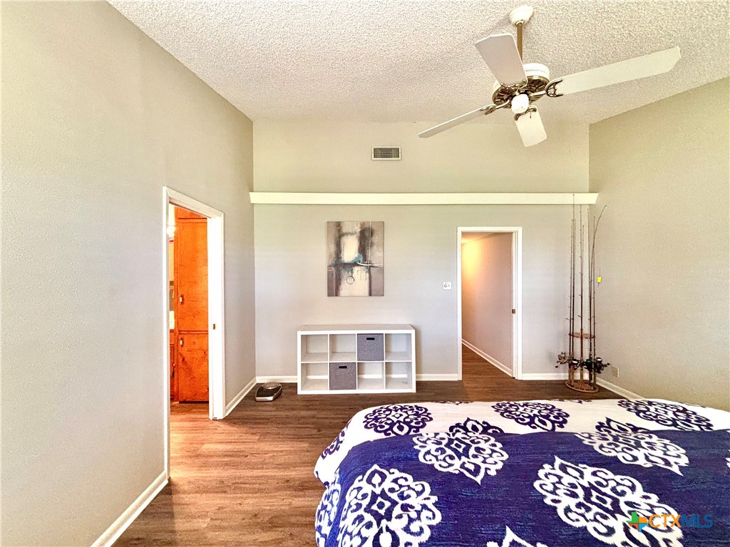 503 16th Street Port O'Connor, TX 77982 - Photo 26 of 48 a bedroom with a bed and a chandelier