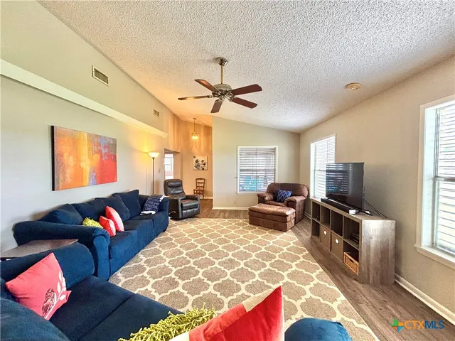 a front view of house with a garden and swimming pool