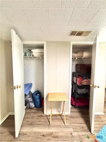 a bedroom with a bed and a night stand